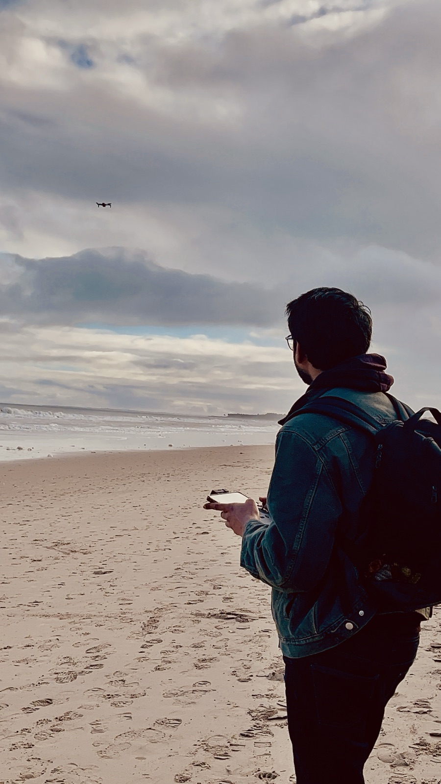 Madan Haribhat flying a drone on a beach